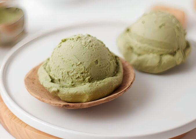 scoops of matcha nice cream with banana and matcha powder