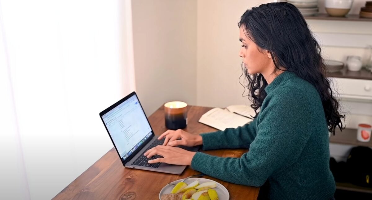 A still from Nisha Vora's video on common mistakes new vegans can make showing her working on a laptop