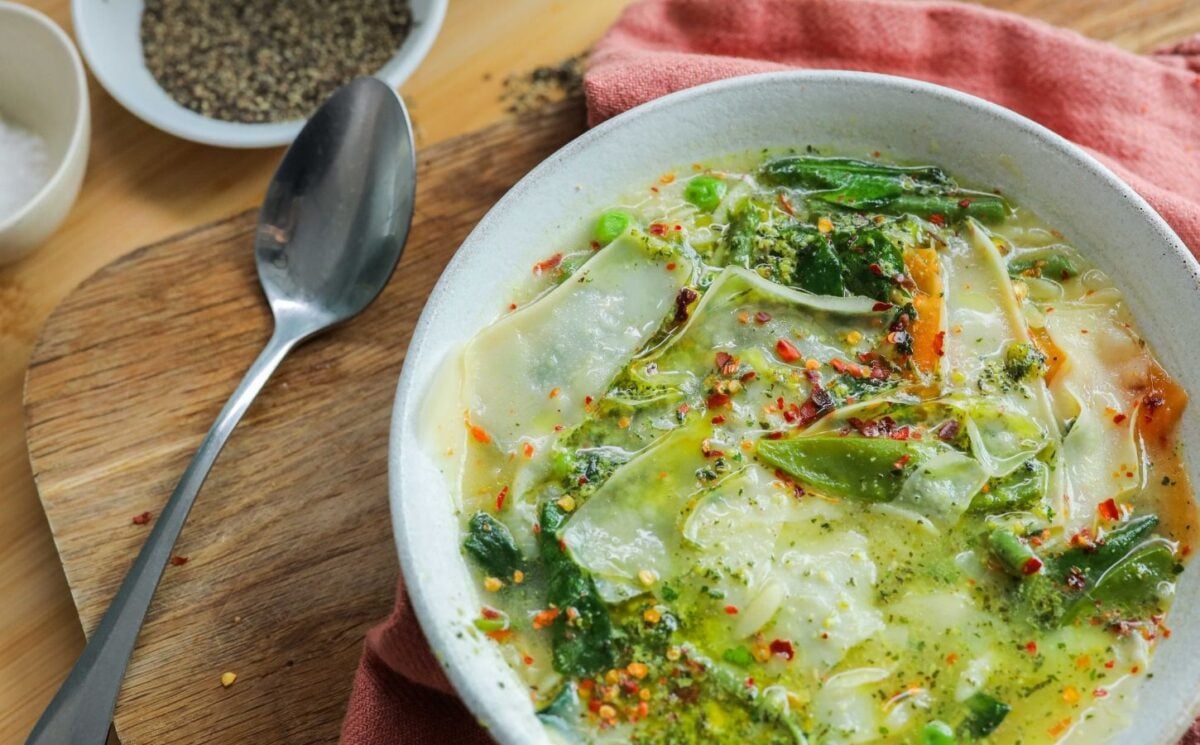 vegan green minestrone soup with pistachio pesto and vegetables