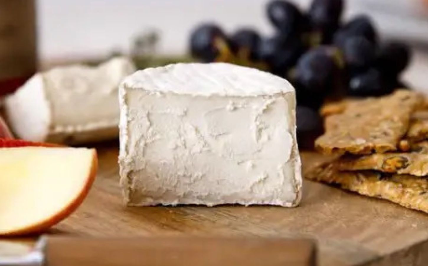 Artistic photo of Mouldy Goaty vegan goats cheese on wooden board
