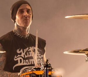 Blink 182 star and vegan celebrity Travis Barker playing the drums on stage