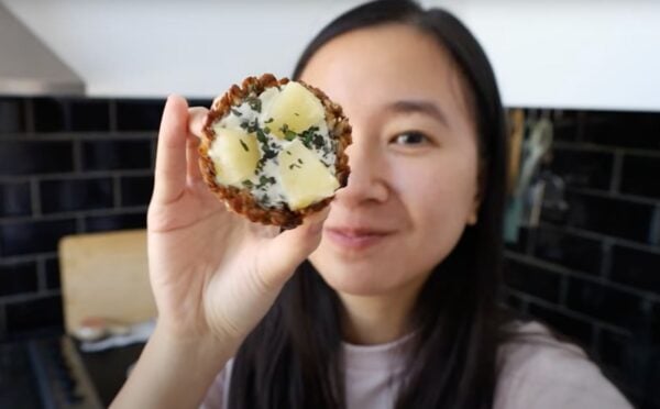A vegan recipe developer holding up her vegan granola cup recipe