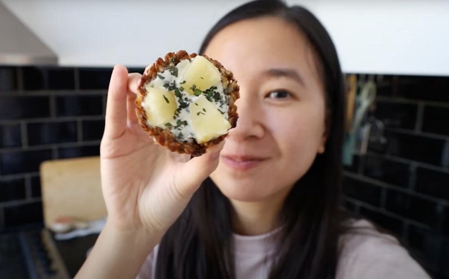 A vegan recipe developer holding up her vegan granola cup recipe